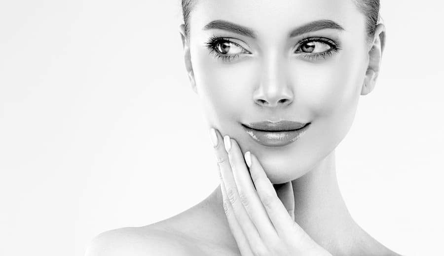 closeup of woman touching face