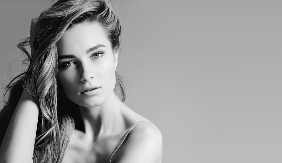 woman holding hair and looking forward