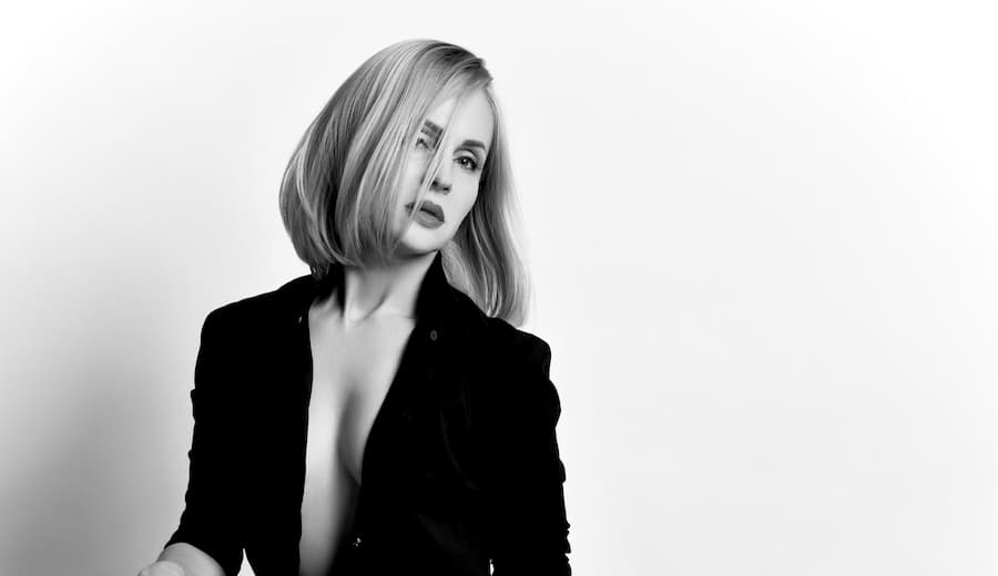 greyscale photo of woman in a coat