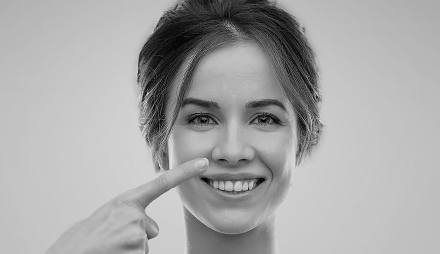 woman pointing to her wide nose