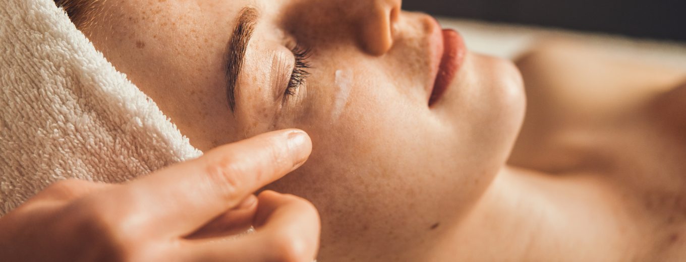 Woman undergoing facial spa treatment