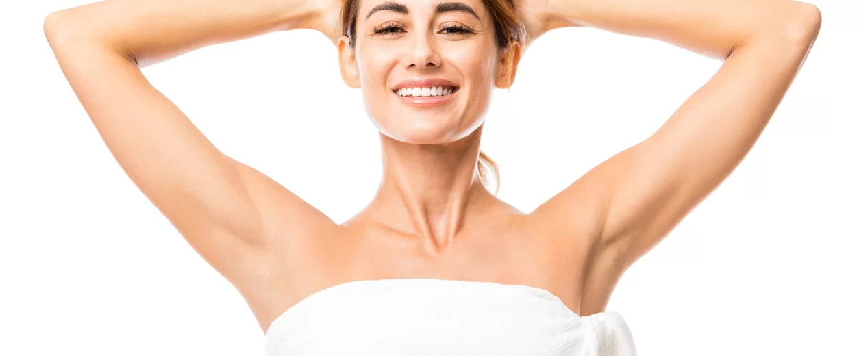 Smiling woman after shaving her underarms.